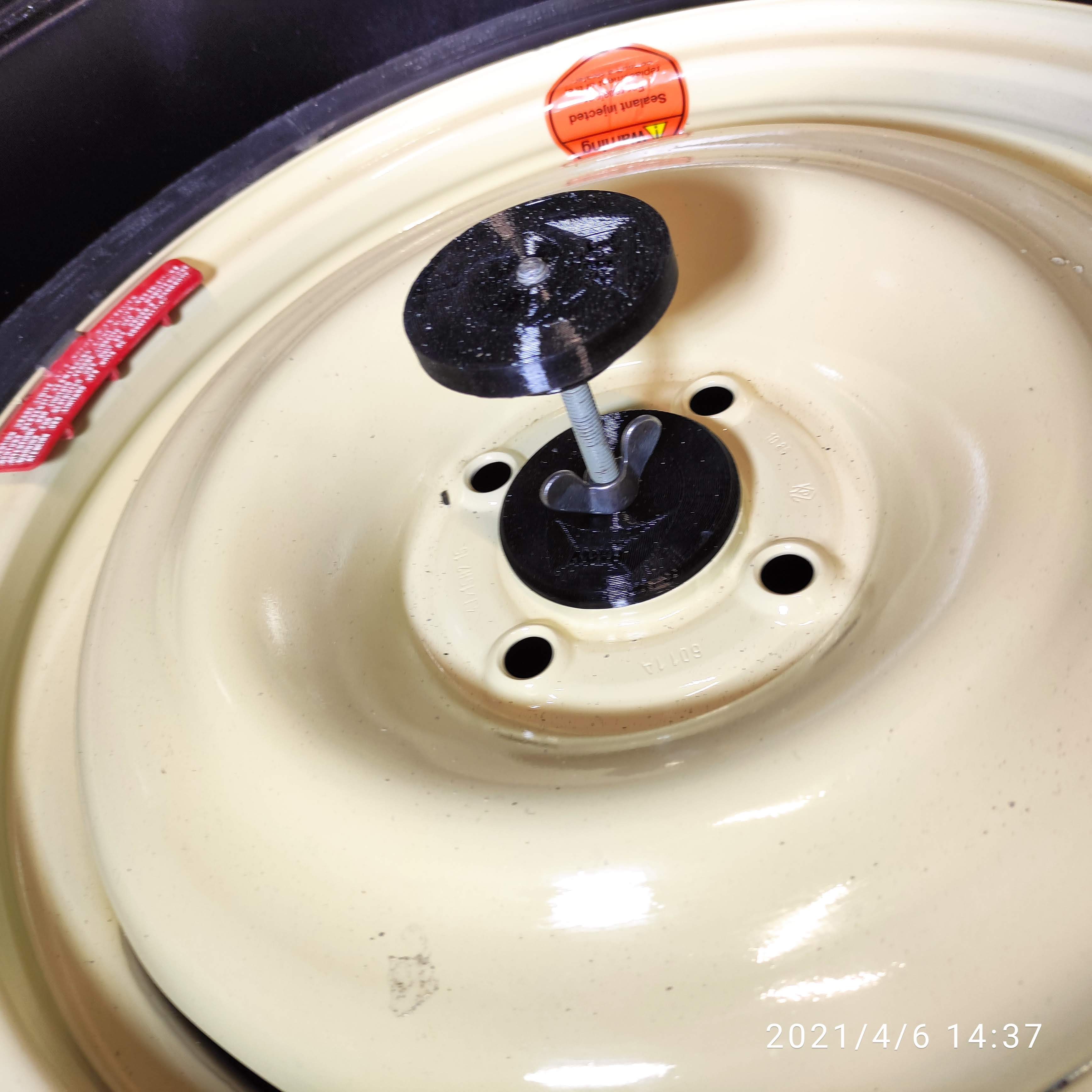 Spare-Wheel Retaining Cover and Holder